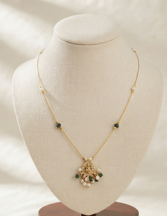 Invisible chain green stone necklace with emerald teardrop pendant and pearl accents